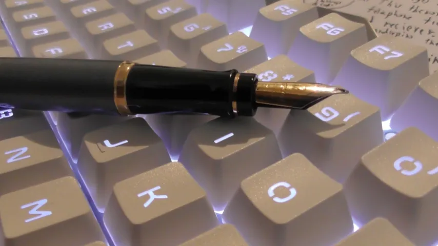Stylish pen on a lit keyboard